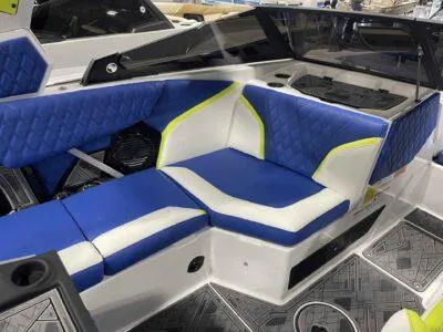 Slide: The Image of 2024 Tigé 24RZX boat interior with blue and white seating, modern design. - 9