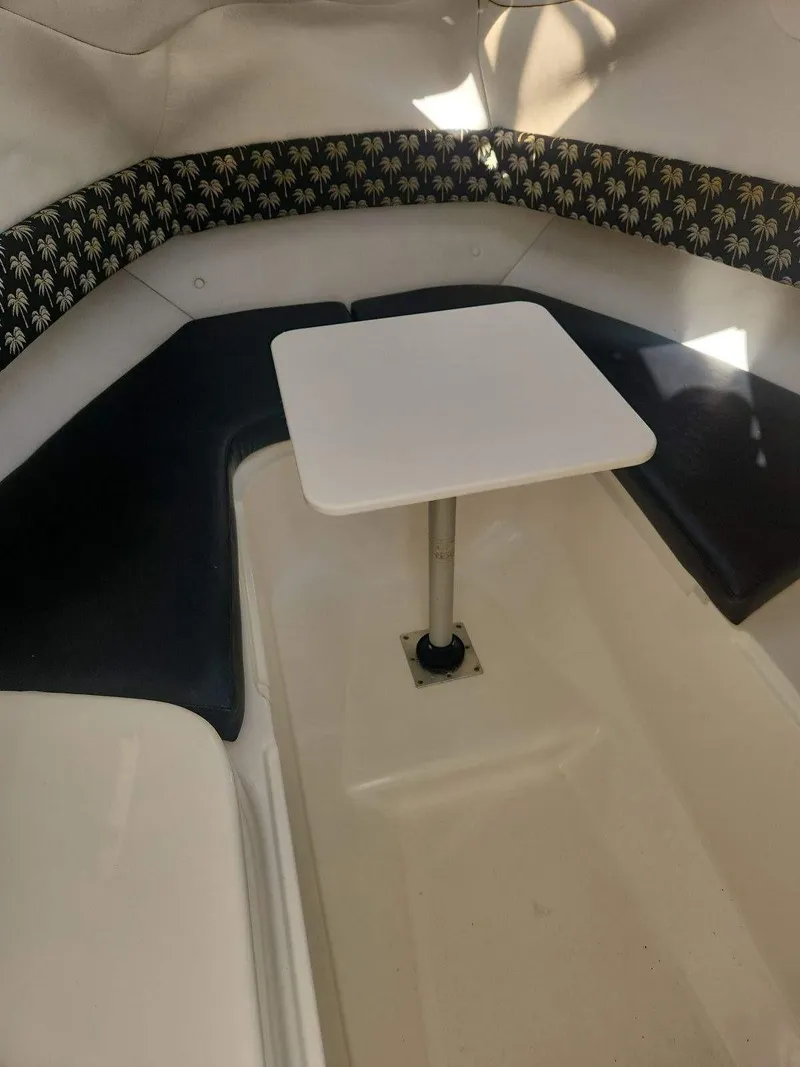 Slide: The Image of Interior of a 2003 Century 2300V boat with seating and a central table. - 3