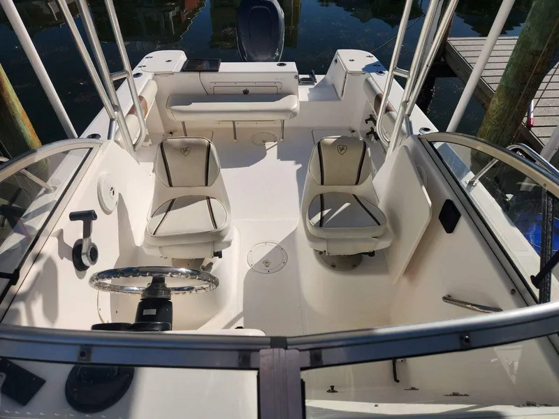 Slide: The Image of 2003 Century 2300V boat interior with dual seats and steering wheel. - 6