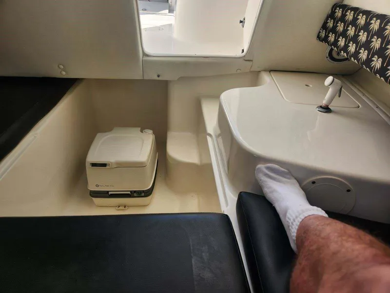 Slide: The Image of Interior of a 2003 Century 2300V boat with portable toilet and seating area. - 8