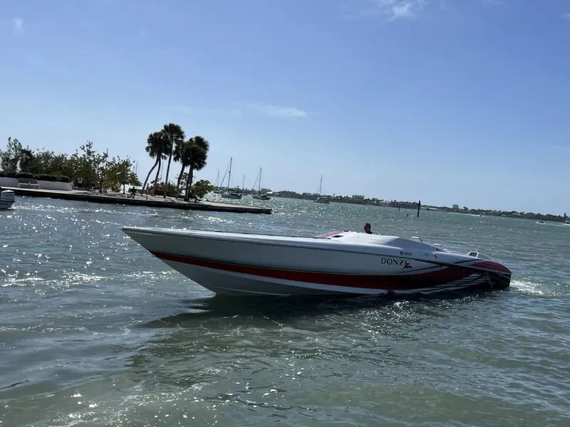 Slide: The Image of 2008 Donzi 43 ZR speedboat cruising on a sunny day in a scenic bay. - 0