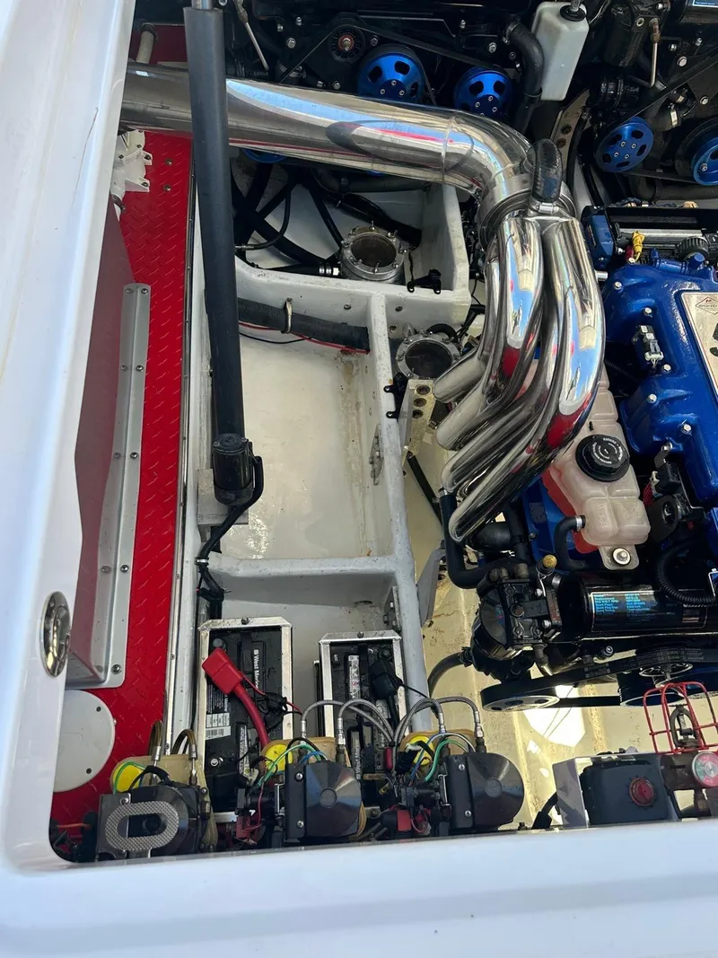 Slide: The Image of Engine compartment of a 2008 Donzi 43 ZR boat, featuring chrome exhaust pipes. - 10