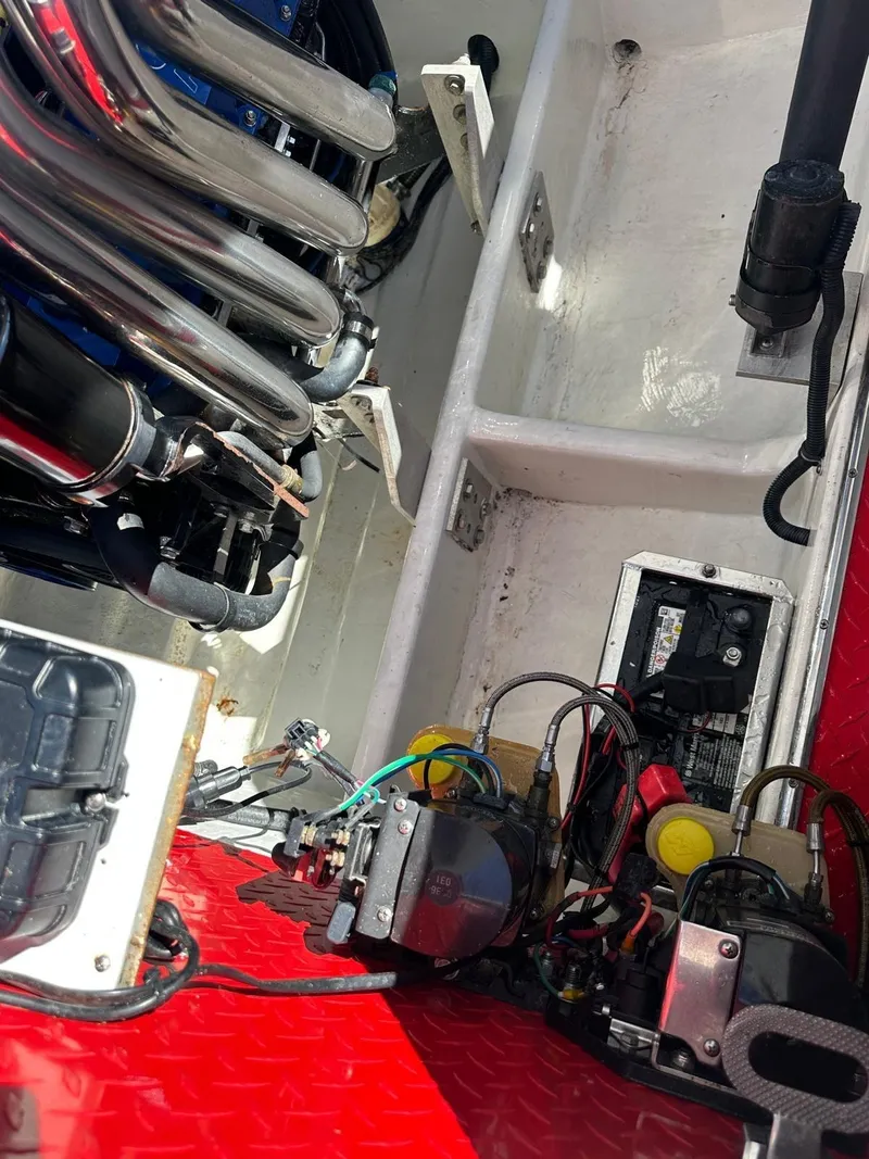 Slide: The Image of Engine compartment of a 2008 Donzi 43 ZR boat, showing mechanical components and wiring. - 12