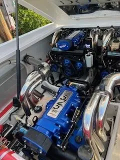 Slide: The Image of 2008 Donzi 43 ZR engine compartment with powerful blue engine and chrome exhaust. - 14