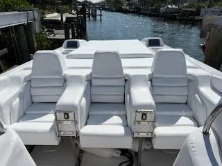 Slide: The Image of 2008 Donzi 43 ZR boat with white seating, docked by a serene waterfront. - 21