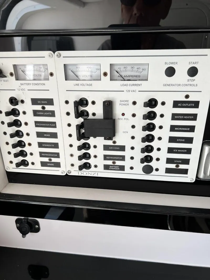 Slide: The Image of Control panel of a 2008 Donzi 43 ZR boat with various switches and gauges. - 22
