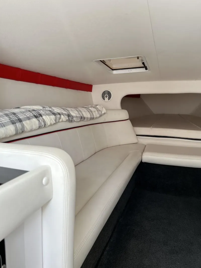 Slide: The Image of Interior of 2008 Donzi 43 ZR boat with white seating and plaid pillow. - 23