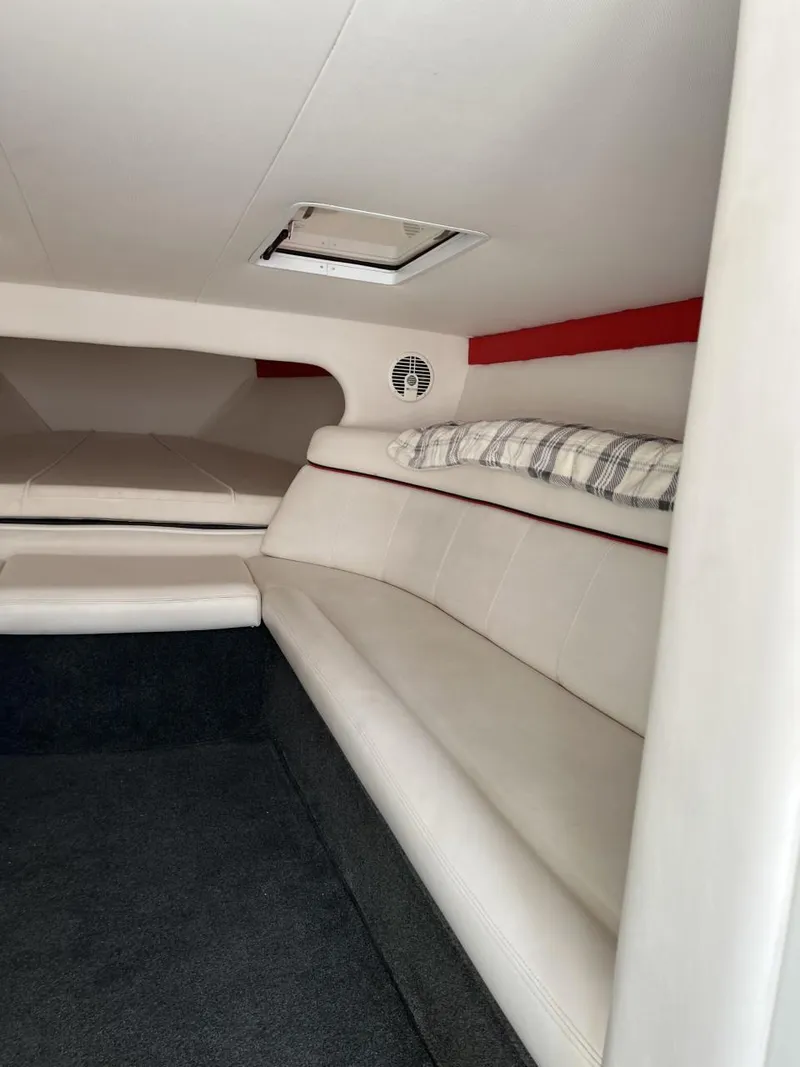 Slide: The Image of Interior of 2008 Donzi 43 ZR boat with white seating and plaid pillow. - 24