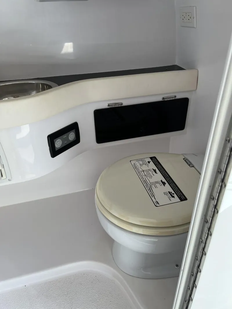 Slide: The Image of Interior of a 2008 Donzi 43 ZR boat bathroom with toilet and sink. - 26