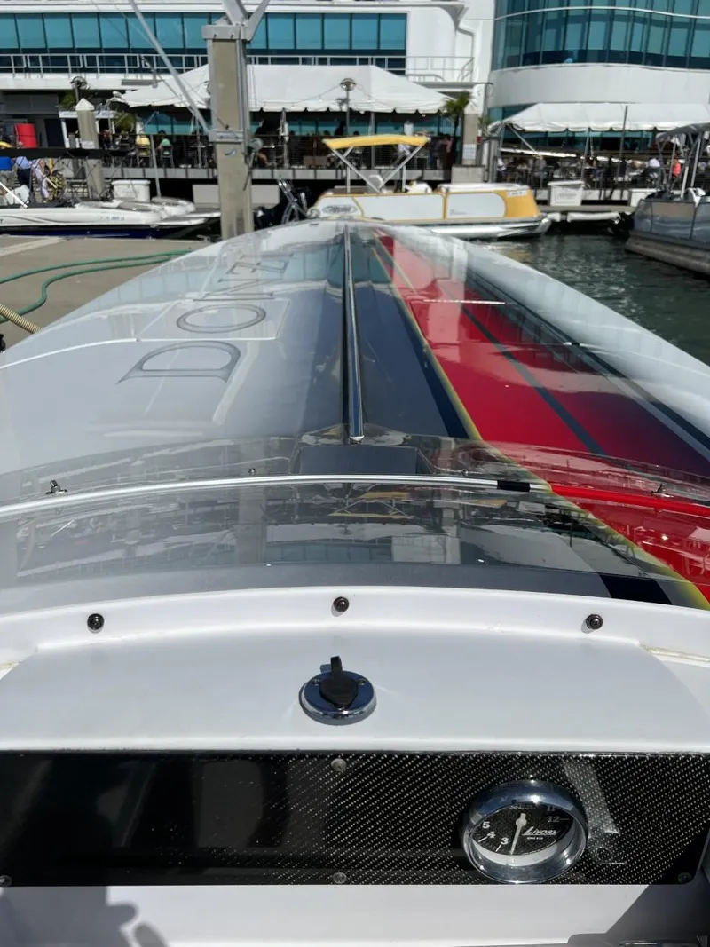Slide: The Image of 2008 Donzi 43 ZR speedboat docked at a marina, showcasing sleek design and vibrant colors. - 27