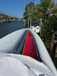 Slide: The Image of 2008 Donzi 43 ZR speedboat docked on a sunny canal, featuring sleek design and vibrant colors. - 29