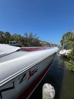 Slide: The Image of 2008 Donzi 43 ZR speedboat docked on a sunny day, side view. - 33