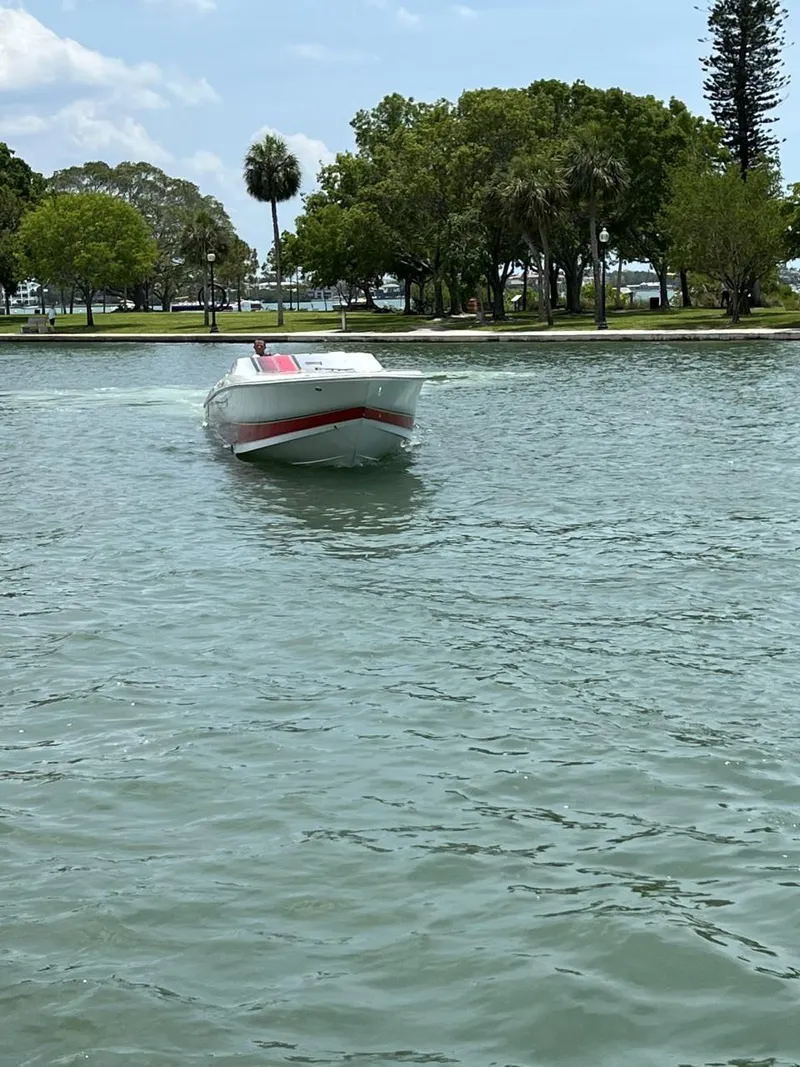 Slide: The Image of 2008 Donzi 43 ZR speedboat cruising on a calm lake with trees in the background. - 5