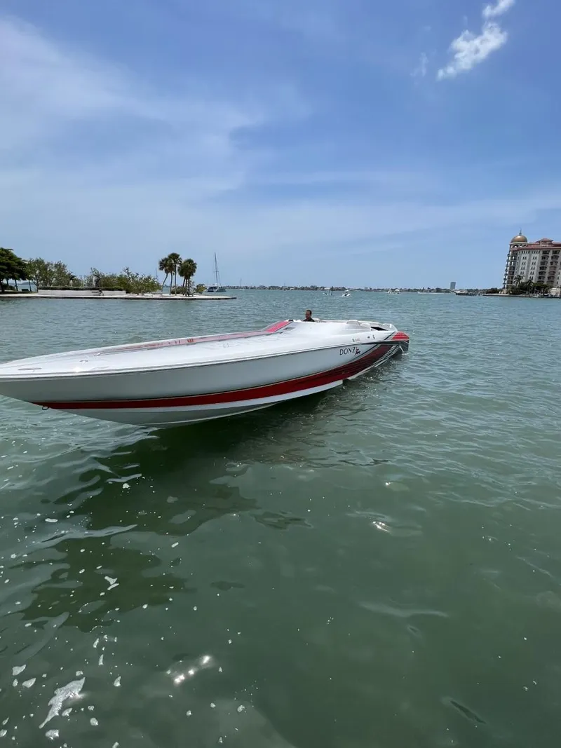 Slide: The Image of 2008 Donzi 43 ZR speedboat on calm water under a clear blue sky. - 7