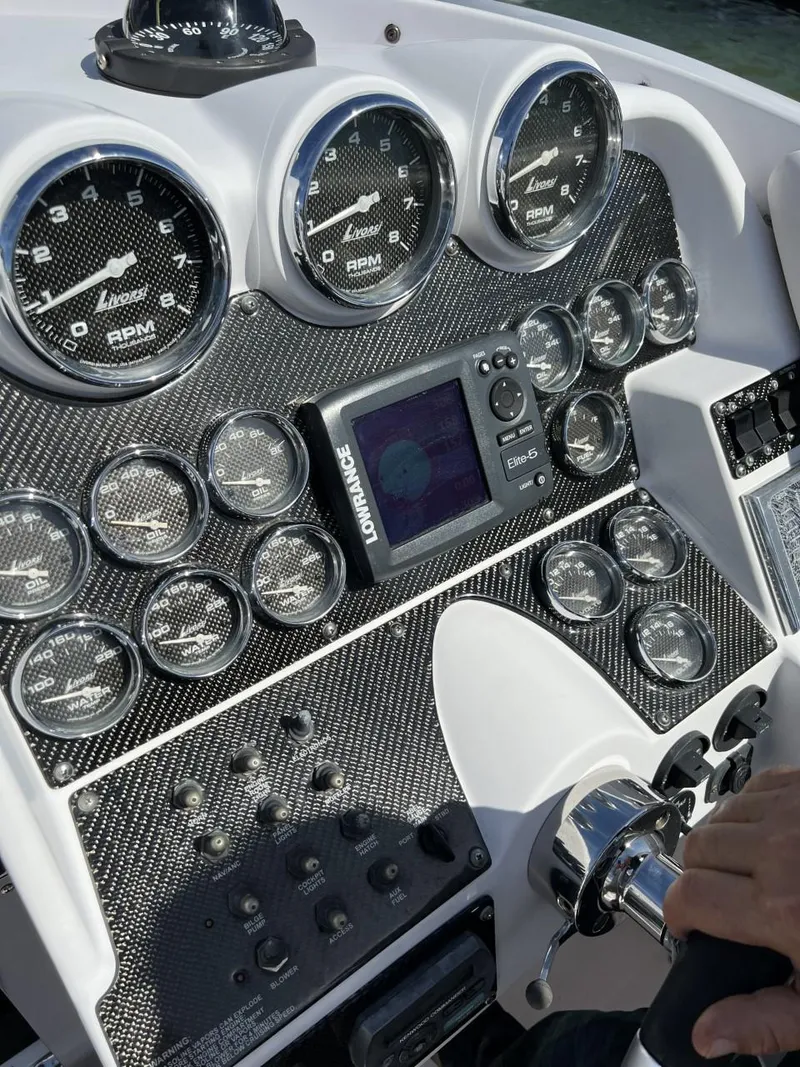 Slide: The Image of Dashboard of a 2008 Donzi 43 ZR boat with multiple gauges and controls. - 8