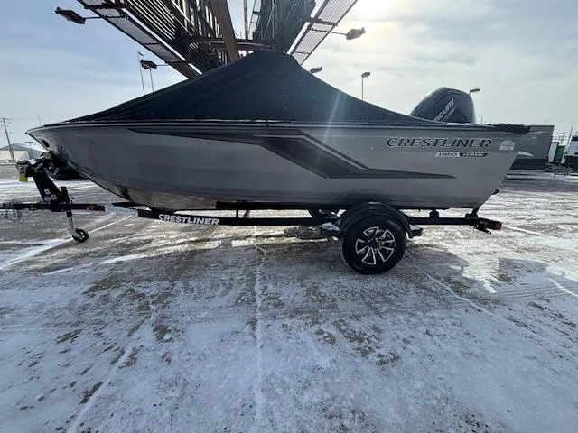 Slide: The Image of 2025 Crestliner 1650 Hawk boat on trailer, covered, in snowy outdoor setting. - 0