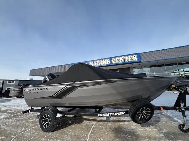 Slide: The Image of 2025 Crestliner 1650 Hawk boat on trailer at marine center. - 1