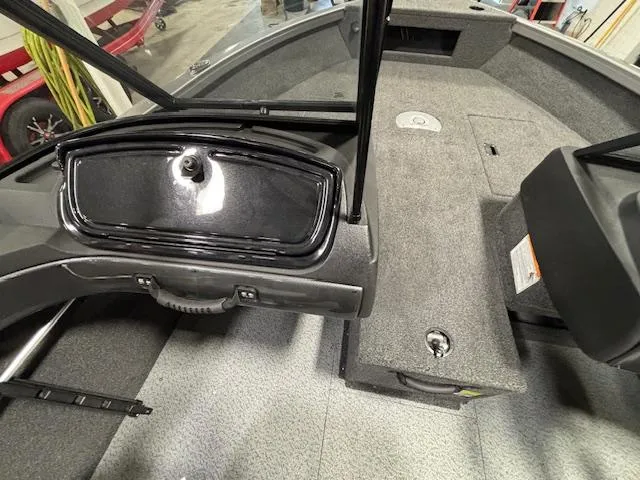 Slide: The Image of 2025 Crestliner 1650 Hawk boat interior with storage compartments and seating area. - 12