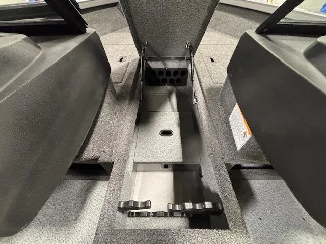 Slide: The Image of 2025 Crestliner 1650 Hawk interior storage compartment, open lid, showcasing organized space. - 13