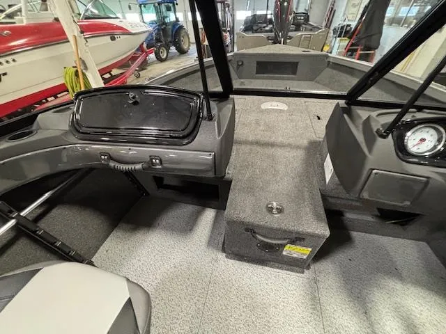 Slide: The Image of Interior view of 2025 Crestliner 1650 Hawk boat, showcasing dashboard and seating area. - 15