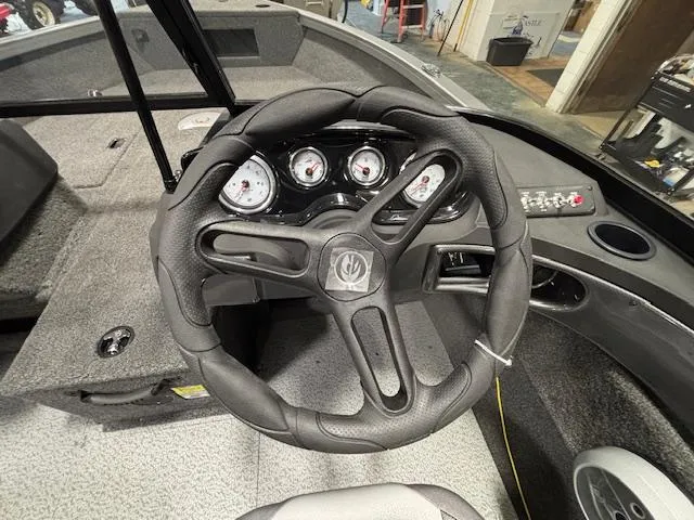 Slide: The Image of Steering wheel and dashboard of 2025 Crestliner 1650 Hawk boat, featuring modern gauges. - 17