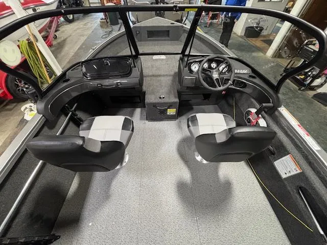 Slide: The Image of 2025 Crestliner 1650 Hawk boat interior with dual seats and steering console. - 19