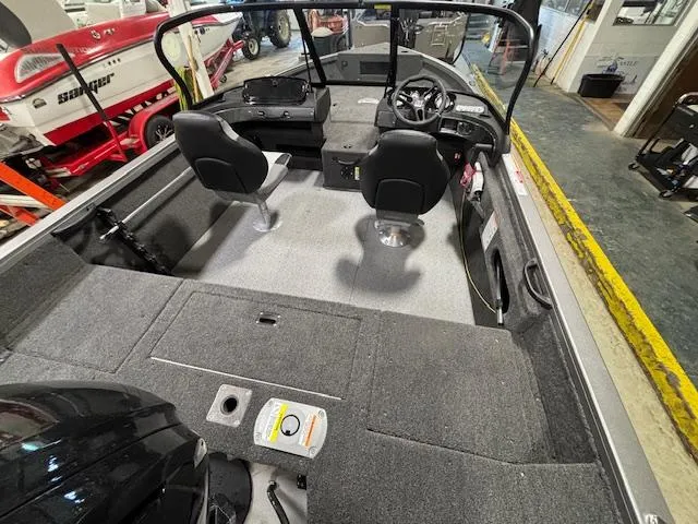 Slide: The Image of 2025 Crestliner 1650 Hawk boat interior with dual seats and steering console. - 21