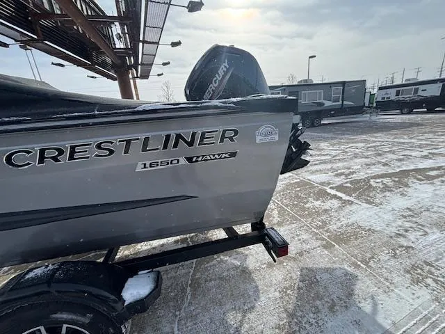 Slide: The Image of 2025 Crestliner 1650 Hawk boat on snowy lot with Mercury engine. - 25