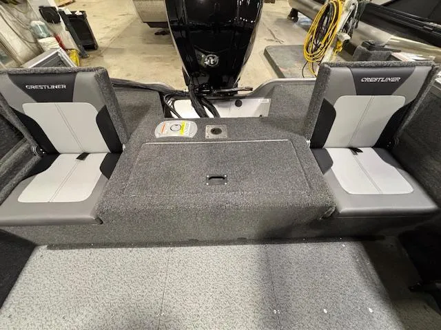 Slide: The Image of 2025 Crestliner 1650 Hawk boat interior with dual seats and motor. - 3