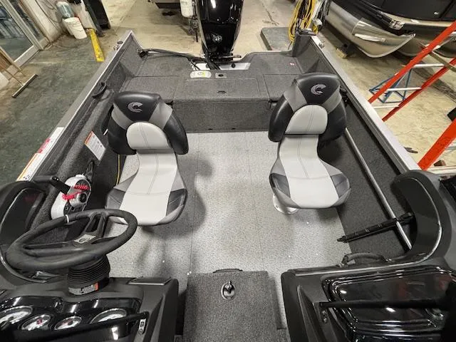 Slide: The Image of 2025 Crestliner 1650 Hawk boat interior with two seats and steering console. - 5