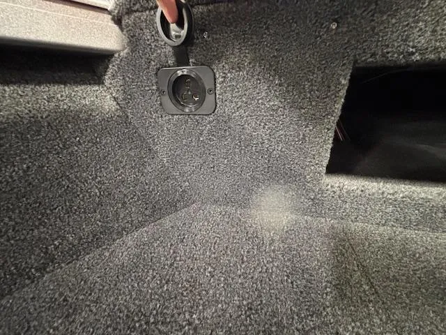 Slide: The Image of 2025 Crestliner 1650 Hawk interior with carpeted flooring and electrical outlet. - 6