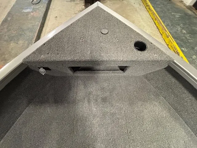 Slide: The Image of 2025 Crestliner 1650 Hawk boat interior, featuring a textured deck and storage compartments. - 8