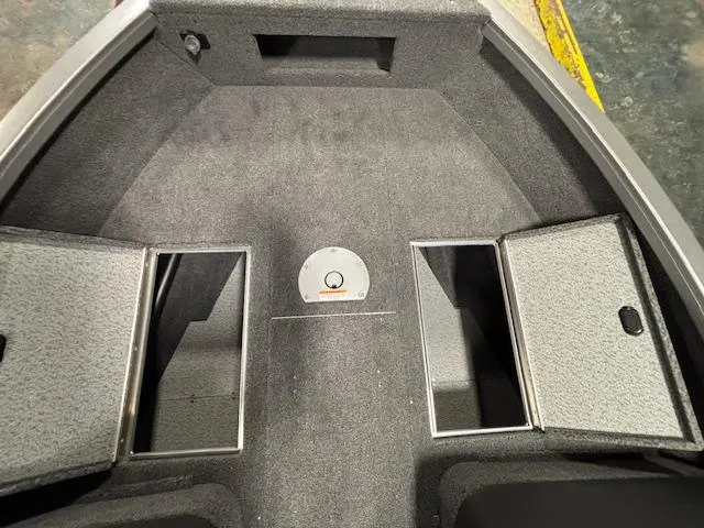 Slide: The Image of 2025 Crestliner 1650 Hawk boat interior with storage compartments and carpeted flooring. - 9