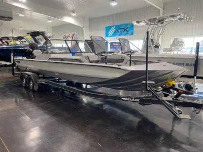 The Image of 2025 SeaArk EasyCat boat on trailer in showroom, featuring sleek design and modern amenities. - 1