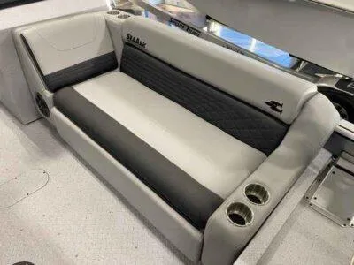Slide: The Image of 2025 SeaArk EasyCat boat interior with cushioned seating and cup holders. - 10