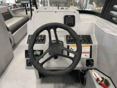 Slide: The Image of Steering console of 2025 SeaArk EasyCat boat with modern controls and dashboard. - 14