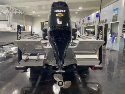 Slide: The Image of 2025 SeaArk EasyCat boat with powerful 300 HP engine, displayed indoors. - 4