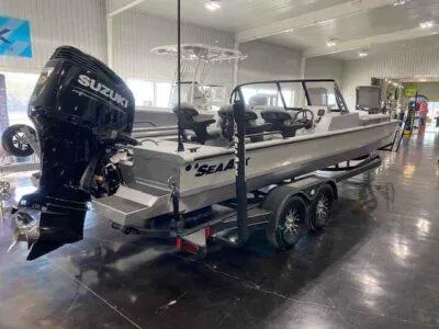 Slide: The Image of 2025 SeaArk EasyCat boat with Suzuki engine on trailer in showroom. - 5