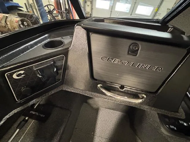 Slide: The Image of 2025 Crestliner 1750 Fish Hawk interior with storage compartment and control panel. - 11