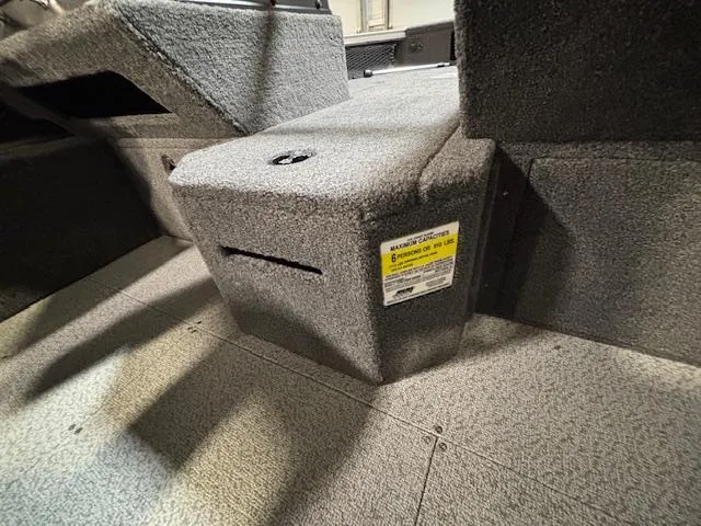 Slide: The Image of 2025 Crestliner 1750 Fish Hawk interior, featuring carpeted storage compartment. - 14