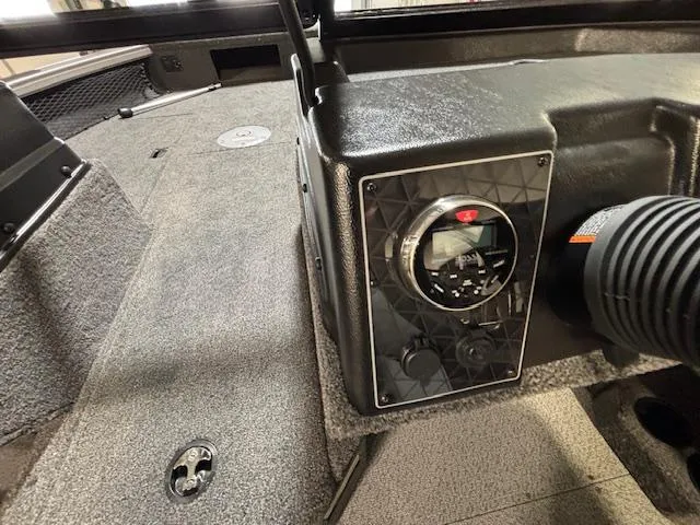 Slide: The Image of 2025 Crestliner 1750 Fish Hawk interior dashboard with control panel and carpeted flooring. - 16