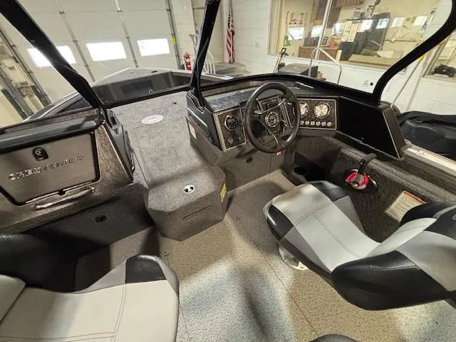 Slide: The Image of 2025 Crestliner 1750 Fish Hawk boat interior with steering wheel and seating. - 19