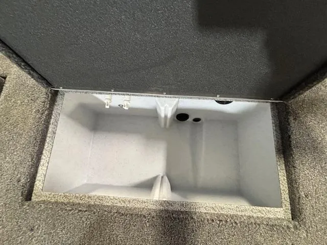 Slide: The Image of 2025 Crestliner 1750 Fish Hawk storage compartment, open and empty. - 2
