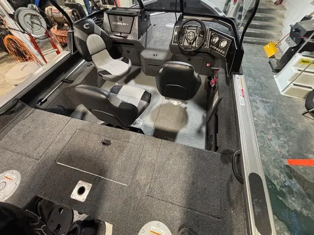 Slide: The Image of 2025 Crestliner 1750 Fish Hawk boat interior with seating and dashboard. - 22
