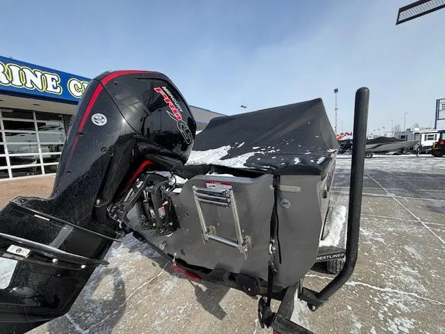 Slide: The Image of 2025 Crestliner 1750 Fish Hawk boat with covered motor, parked on snowy pavement. - 25