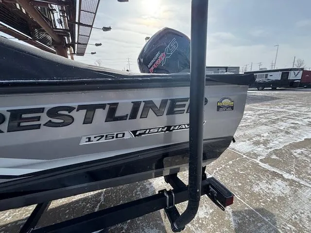 Slide: The Image of 2025 Crestliner 1750 Fish Hawk boat on a snowy lot, showcasing its sleek design. - 27
