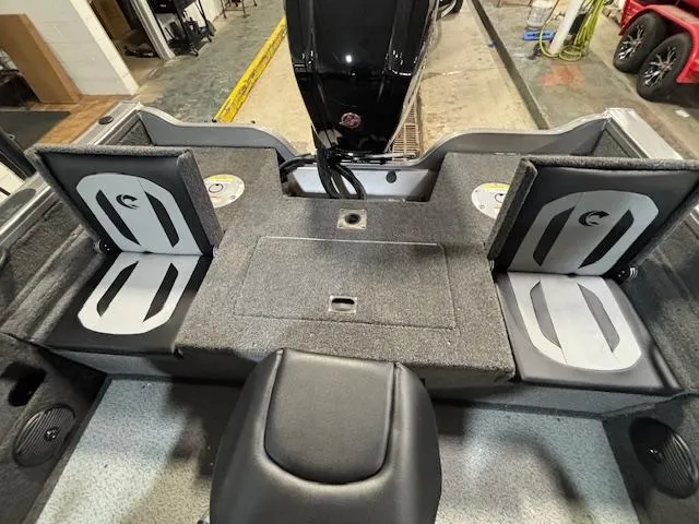 Slide: The Image of 2025 Crestliner 1750 Fish Hawk interior with foldable seats and motor view. - 3