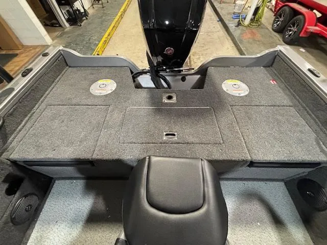 Slide: The Image of 2025 Crestliner 1750 Fish Hawk boat interior with carpeted deck and storage compartments. - 4