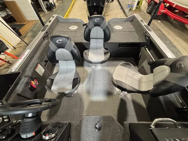 Slide: The Image of 2025 Crestliner 1750 Fish Hawk interior with four seats and steering console. - 5