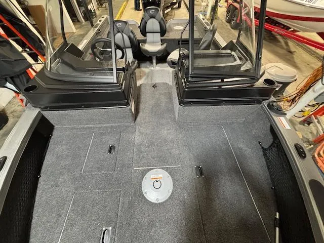 Slide: The Image of 2025 Crestliner 1750 Fish Hawk boat interior with spacious seating and storage compartments. - 7